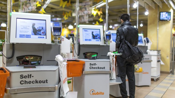 A customer uses the self-checkout, pictured on March 5, 2013, at the Migros branch in Baden, Switzerland. Migros is Switzerland&#039;s the largest retail company. (KEYSTONE/Gaetan Bally)

Ein Kunde be ...