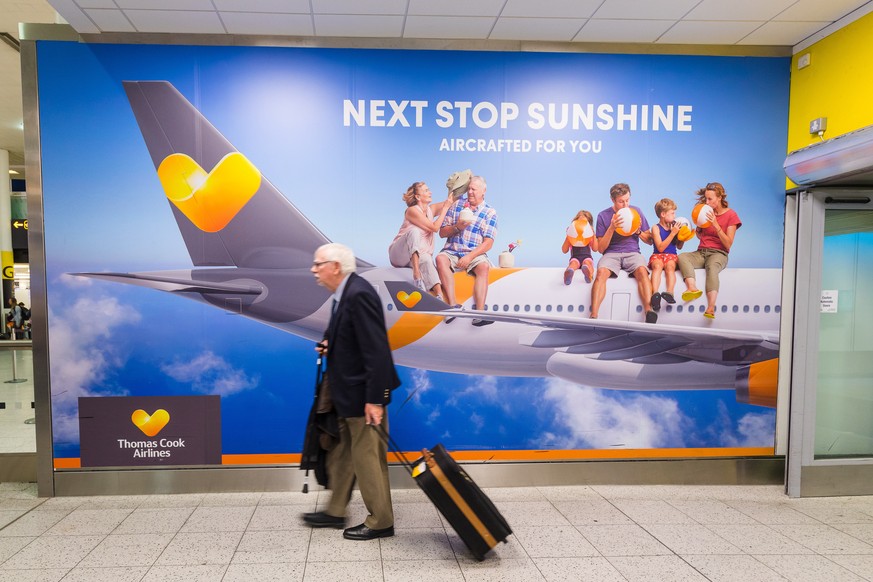 epa07864111 A man walks past a Thomas Cook advertising board at Gatwick Airport in Sussex, England, Britain, 23 September 2019. More than 600,000 vacation reservations were canceled on 23 September, a ...