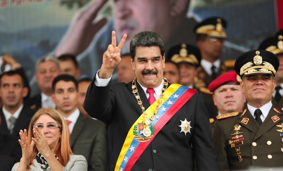 epa06837842 A handout photograph made available by Miraflores shows President of Venezuela, Nicolas Maduro (C), along with First Lady, Cilia Flores (L), during an act to celebrate the 197th anniversar ...
