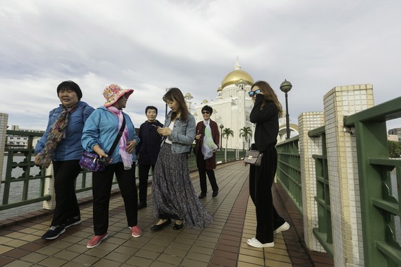epa07479846 A group of Chinese tourists tours inside the Sultan Omar Ali Saifuddien mosque in Bandar Seri Begawan, Brunei, 01 April 2019 (issued 02 April 2019). The Sultanate of Brunei will move towar ...