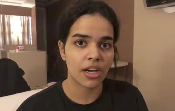 In this Monday, Jan. 7, 2019, image made from video released by Rahaf Mohammed Alqunun/Human Rights Watch, Rahaf Mohammed Alqunun views her mobile phone as she sits barricaded in a hotel room at an in ...