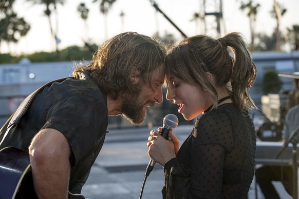 This image released by Warner Bros. shows Bradley Cooper, left, and Lady Gaga in a scene from the latest reboot of the film, &quot;A Star is Born.&quot; The film led nominations for the 25th Screen Ac ...