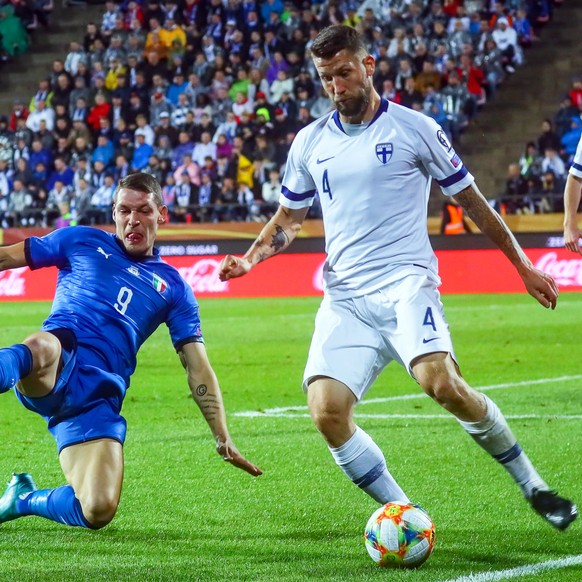 epa07828765 Joona Toivio (R) of Finland in action against Andrea Belotti (L) of Italy during the UEFA EURO 2020 group J qualifying soccer match between Finland and Italy in Tampere, Finland, 08 Septem ...