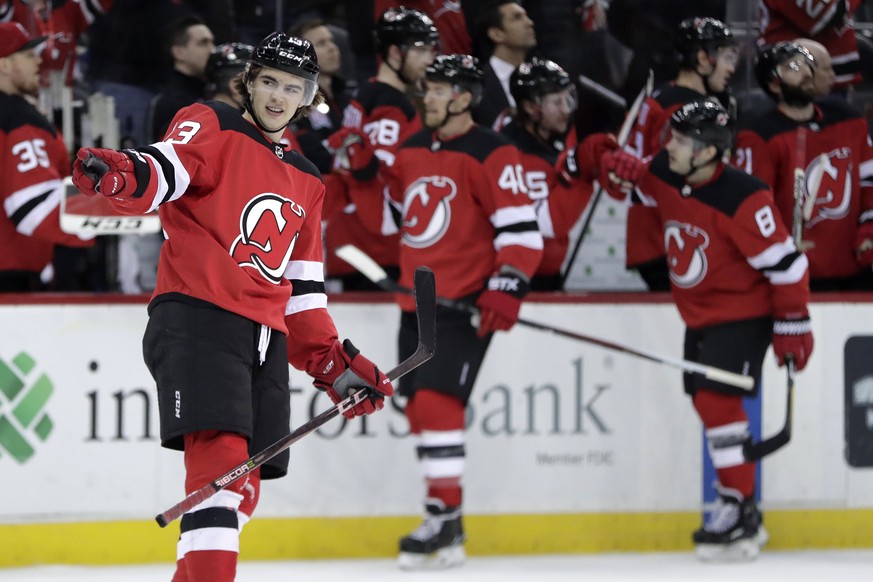 New Jersey Devils center Nico Hischier, of Switzerland, gestures toward teammate goalie Keith Kinkaid, not pictured, after scoring a goal on the Tampa Bay Lightning during the first period of an NHL h ...
