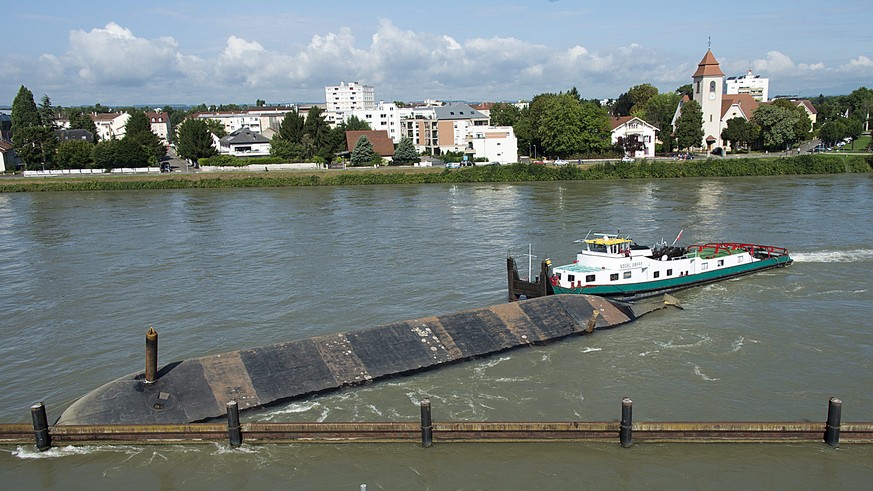 epa04340387 The capsized cargo boat Merlin lies secured on the Rhein border in the Basel, region, Switzerland, where three countries meet, 04 August 2014. EPA/GEORGIOS KEFALAS