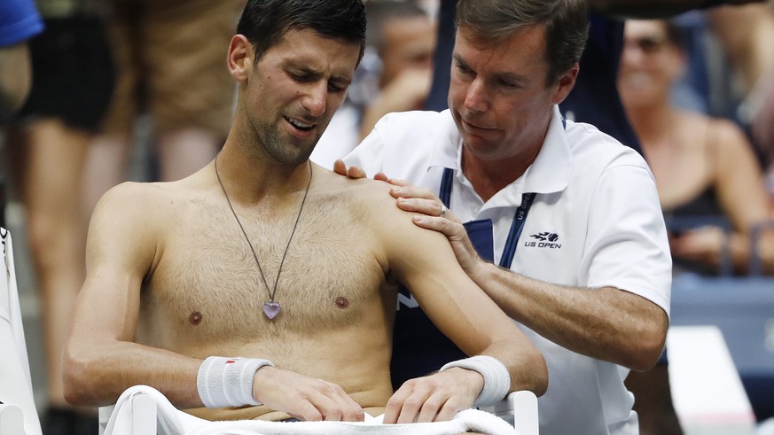 epa05532491 Novak Djokovic of Serbia receives treatment for his shoulder as he plays Gael Monfils of France during their semifinal round match on the twelfth day of the US Open Tennis Championships at ...