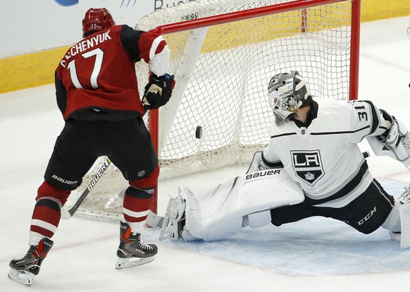 Los Angeles Kings goalie Peter Budaj (31) makes a pad save on a shot by Arizona Coyotes center Alex Galchenyuk (17) during the second period of an NHL preseason hockey game Tuesday, Sept. 18, 2018, in ...