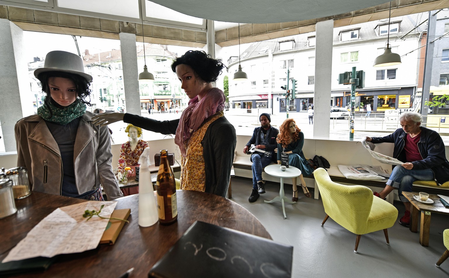 Display mannequins are placed between customers at the Cafe Livres in Essen, Germany, Wednesday, May 20, 2020. The cafe set the dolls as placeholders on various places for more distance between custom ...