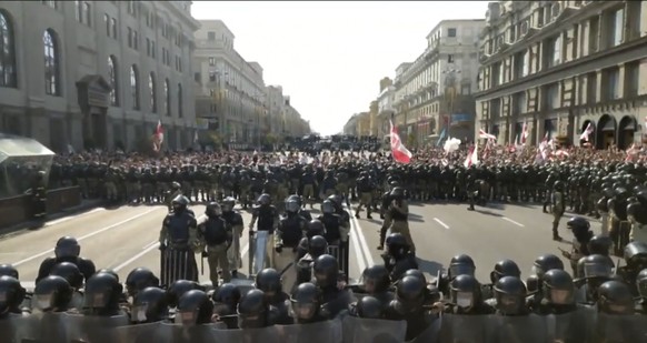 In this video grab taken from a footage provided by Belsat TV via Associated Press Television, Riot police line block a street to protect against Belarusian opposition supporters rally in the center o ...