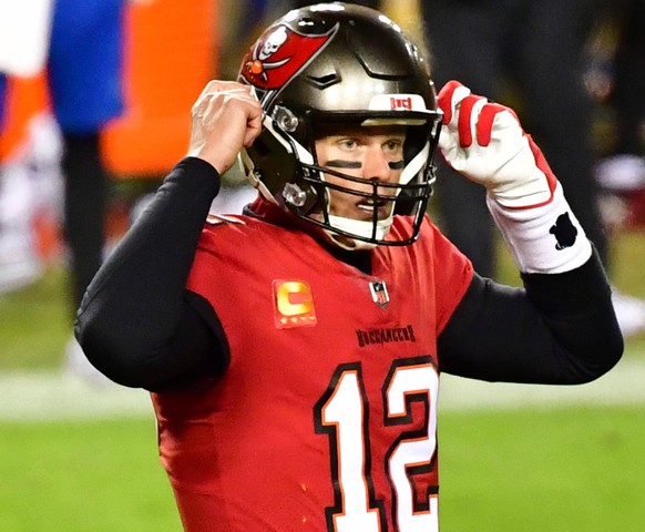 Tampa Bay Buccaneers quarterback Tom Brady 12 calls an audible against the Washington Football Team during the second half of a wild card playoff game at FedEx Field in Landover, Maryland on Saturday, ...