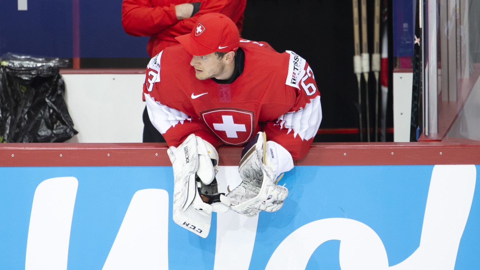 Switzerland&#039;s goaltender Leonardo Genoni looks his teammates from the bench after his substitution, during the IIHF 2021 World Championship preliminary round game between Switzerland and Sweden,  ...