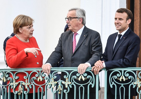 epa06822275 (L-R) German Chancellor Angela Merkel, European Commission President Jean-Claude Juncker and French President Emmanuel Macron talks as pose for photo during the German-French Minister Meet ...