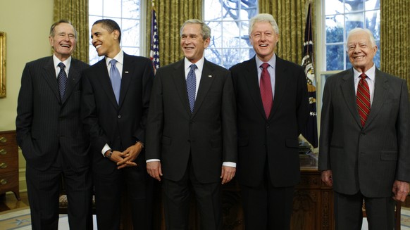 FILE - In this Jan. 7, 2009, file photo President-elect Barack Obama is welcomed by President George W. Bush for a meeting at the White House in Washington with former presidents, from left, George H. ...
