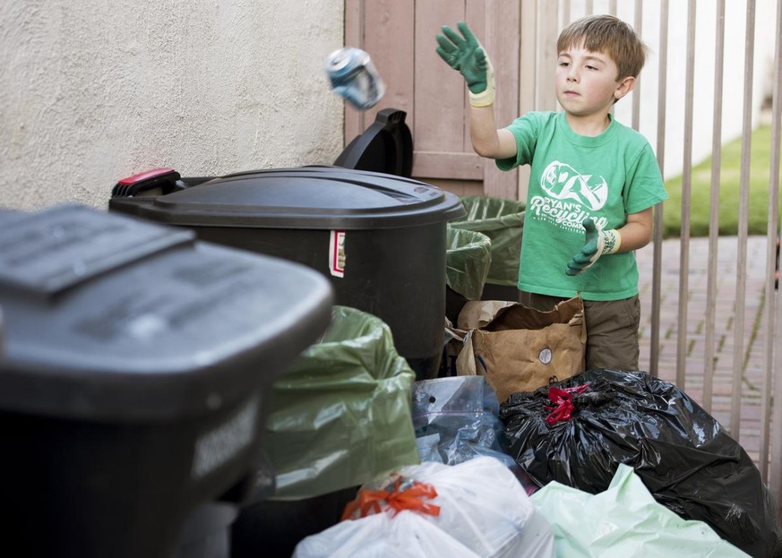 Ryan Hickman, 7, sorts recyclables he&#039;s collected from his neighbors in San Juan Capistrano, CA on Tuesday, February 28, 2017.