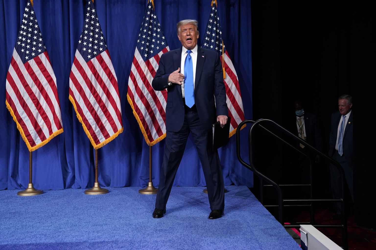 President Donald Trump stands on stage as he visits the Republican National Committee convention site, Monday, Aug. 24, 2020, in Charlotte. White House chief of staff Mark Meadows is at right. (AP Pho ...