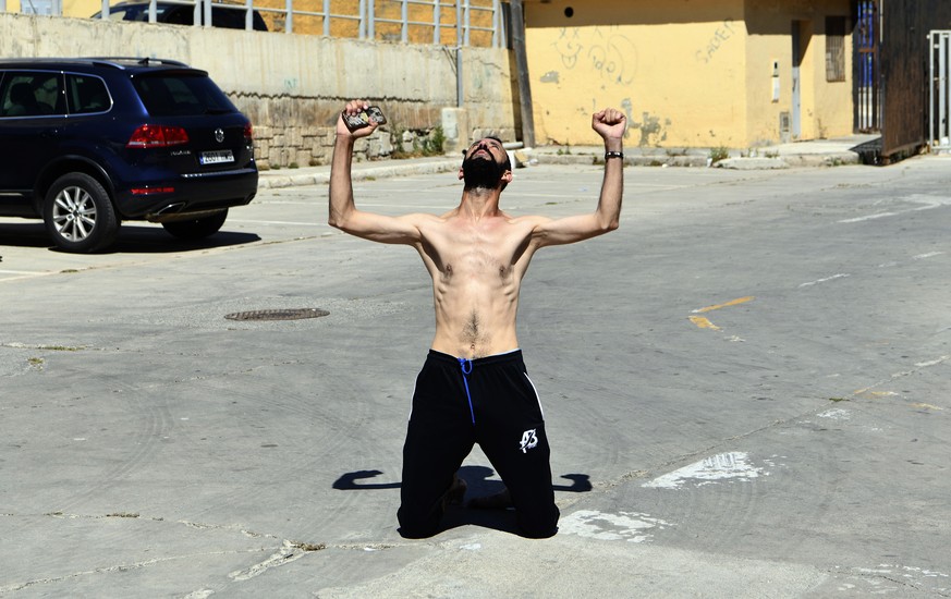 A man from Morocco reacts after entering swimming into the Spanish territory, at the Spanish enclave of Ceuta on Monday, May 17, 2021. Authorities in Spain say that around 1,000 Moroccan migrants have ...