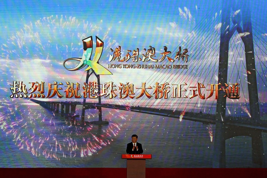 Chinese President Xi Jinping applauds on stage after official opening of the China-Zhuhai-Macau-Hong Kong Bridge, the world&#039;s longest cross-sea project, which has a total length of 55 kilometers  ...