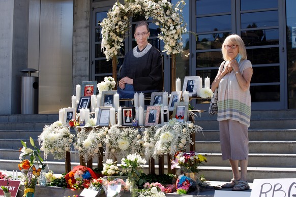 epa08698073 A mourner pays respects at a memorial for US Supreme Court Justice Ruth Bader Ginsburg outside the Skirball Cultural Center in Los Angeles, California, USA, 25 September 2020. Ginsburg die ...
