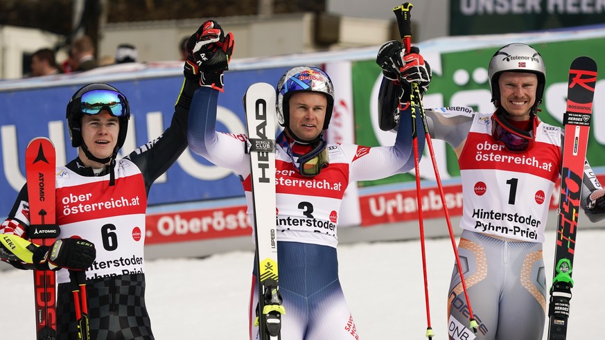 France&#039;s Alexis Pinturault, center, winner of an alpine ski, men&#039;s World Cup giant slalom, celebrates at the finish area with second-placed Croatia&#039;s Filip Zubcic, left, and third-place ...