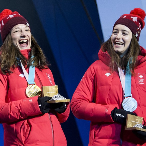 Gold medal winner Sarah Hoefflin of Switzerland, left, and Silver medal winner Mathilde Gremaud of Switzerland, right, celebrate during the victory ceremony on the Medal Plaza for the women Freestyle  ...