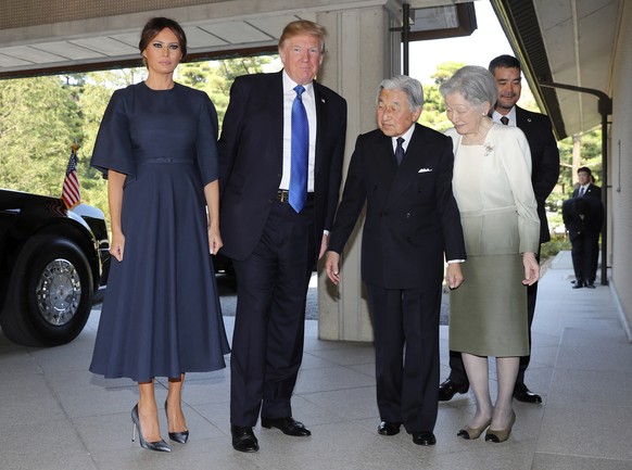 U.S. President Donald Trump, center left, and First Lady Melania Trump, left, are welcomed by Emperor Akihito, second from right, Empress Michiko, right, upon their arrival at the Imperial Palace Mond ...