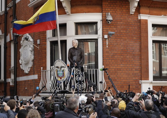 FILE - In this file photo dated Friday May 19, 2017, watched by the media WikiLeaks founder Julian Assange looks out from the balcony of the Ecuadorian embassy prior to speaking, in London. Newly rele ...