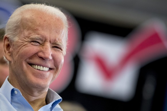 Democratic presidential candidate former Vice President Joe Biden smiles as former Secretary of State John Kerry speaks at a campaign stop at the South Slope Community Center, Saturday, Feb. 1, 2020,  ...