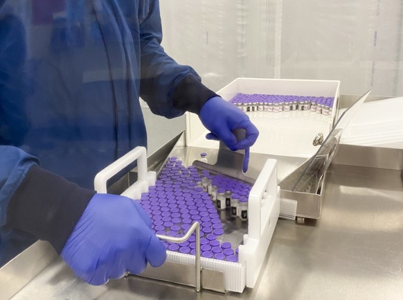 epa08853138 A handout photo made available on 30 November 2020 by pharmaceutical company Pfizer shows vials of Covid-19 vaccine in an undisclosed laboratory on16 November 2020. According to reports Pf ...