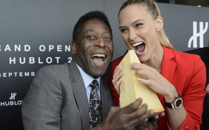 Brazilian soccer legend Pele and Israeli model Bar Refaeli, right, pretend to eat a piece of Gruyere cheese during the inauguration ceremony of an extension of the manufacture of the Swiss luxury watc ...