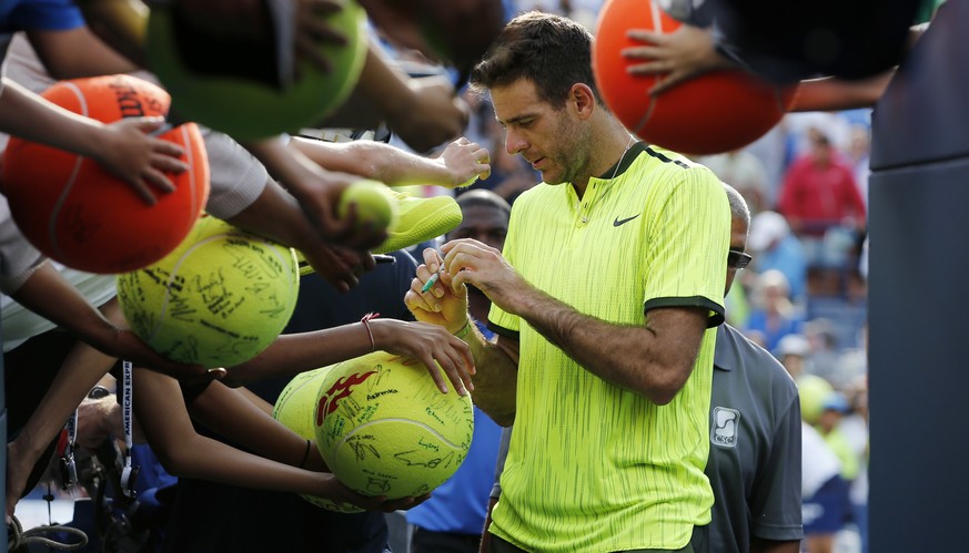 Juan Martin del Potro, of Argentina, signs autographs for fans after defeating David Ferrer, of Spain, during the third round of the U.S. Open tennis tournament, Saturday, Sept. 3, 2016, in New York.  ...
