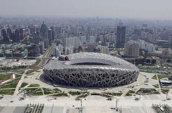 In this aerial photo reviewed by the Chinese military, the National Aquatics Center, known as the Water Cube, foreground, and the National Stadium, also known as the Bird&#039;s Nest, are seen at the  ...
