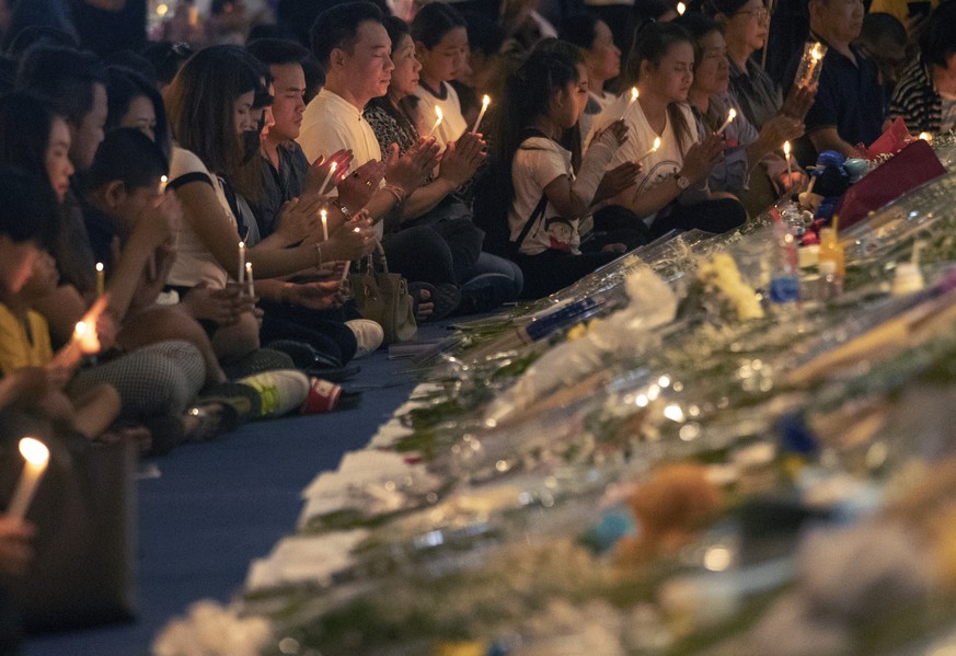 People attend a memorial service at the Terminal 21 Korat shopping mall in Nakhon Ratchasima, Thailand, Monday, Feb. 10, 2020. Authorities in northern Thailand began releasing bodies to relatives afte ...