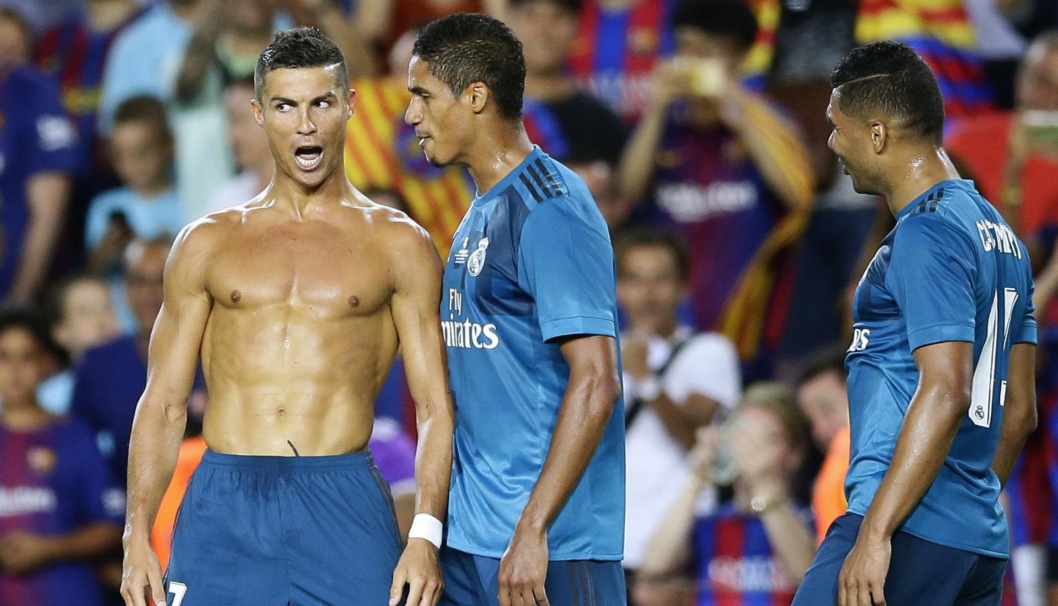 Real Madrid&#039;s Cristiano Ronaldo, left, celebrates after scoring during the Spanish Supercup, first leg, soccer match between FC Barcelona and Real Madrid at the Camp Nou stadium in Barcelona, Spa ...