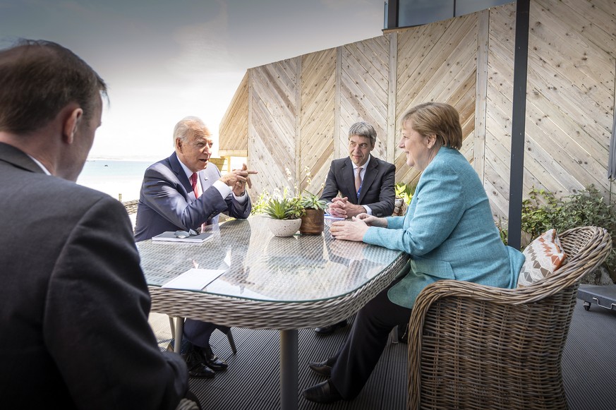 epa09264327 A handout photo made available by the German Government Press Office (BPA) shows German Chancellor Angela Merkel (R) and US President Joe Biden (2-L) at the beginning of their meeting on t ...
