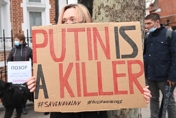 epa09150838 Supporters of Russian opposition leader Alexei Navalny with banner &#039;Putin is a Killer&#039; attend a demonstration organized by the group &#039;Art of Rebel&#039; outside the Russian  ...