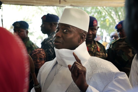 Gambia&#039;s president Yahya Jammeh shows his inked finger before voting in Banjul, Gambia, Thursday, Dec. 1, 2016. Voters in the tiny West African nation of Gambia cast marbles Thursday in an electi ...