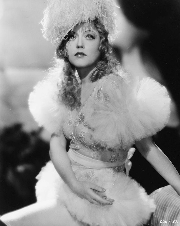 Portrait of actress Marion Davies, wearing wearing a sequin, ruffle dress and hat, circa 1925. (Photo by Archive Photos/Getty Images)