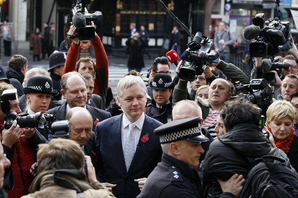 FILE _ In this Wednesday, Nov. 2, 2011 file photo, the founder of WikiLeaks Julian Assange, center, arrives for his extradition hearing at the High Court in London.Police in London arrested WikiLeaks  ...