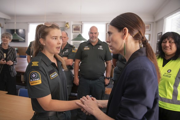 New Zealand&#039;s Prime Minister Jacinda Ardern, right, talks with first responders in Whakatane, New Zealand, Tuesday, Dec. 10, 2019. A volcanic island in New Zealand erupted Monday Dec. 9 in a towe ...
