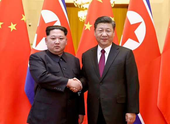 FILE - In this March 28, 2018, file photo, released by China&#039;s Xinhua News Agency, North Korean leader Kim Jong Un, left, and Chinese President Xi Jinping poses for a photo in Beijing. Kim made a ...