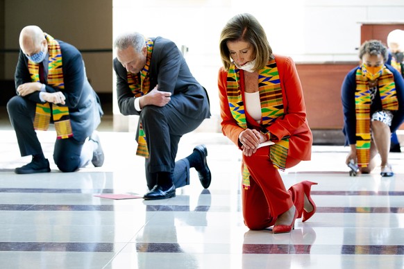epa08473064 US Speaker of the House Nancy Pelosi and Democratic lawmakers kneel while observing a moment of silence to honor George Floyd and victims of racial injustice, on Capitol Hill in Washington ...