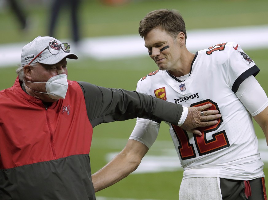 FILE - In this Jan. 17, 2021, file photo, Tampa Bay Buccaneers coach Bruce Arians, left, speaks with quarterback Tom Brady before the team&#039;s NFL divisional round playoff football game against the ...
