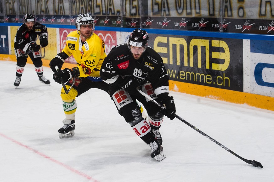 Bern&#039;s player Beat Gerber, left, fight for the puck with Lugano?s player Mikkel Boedker, right, during the preliminary round game of National League A (NLA) Swiss Championship 2020/21 between HC  ...