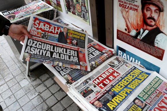 epa05845525 A man buy a Turkish newspaper with a headline &#039;They Suspended freedom&#039; at tea house in Istanbul, Turkey, 13 March 2017. Turkish Family Minister Fatma Betul Sayan Kaya was barred  ...