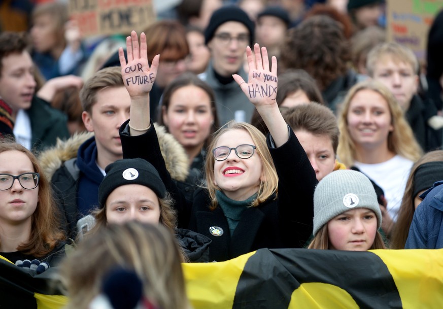epa08032487 Young people take part in a demonstration against climate change during the Youth Climate Strike in Warsaw, Poland, 29 November 2019. Polish youth activists are taking part in protests dem ...