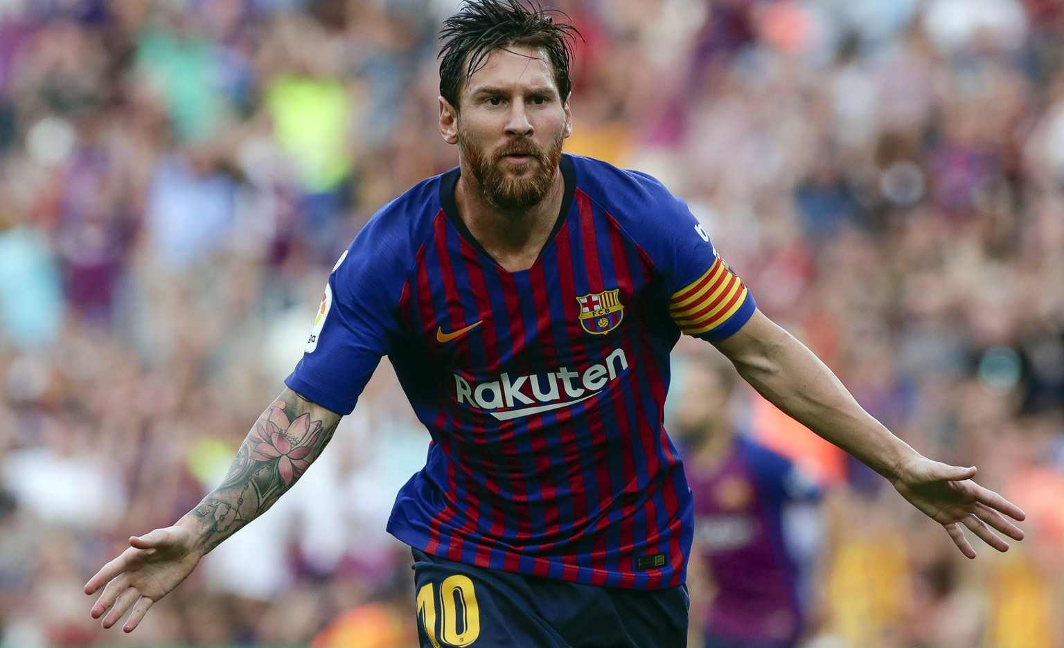 Barcelona&#039;s Lionel Messi celebrates scoring the opening goal during a Spanish La Liga soccer match between Barcelona and Huesca at the Camp Nou stadium in Barcelona, Spain, Sunday Sept. 2, 2018.  ...