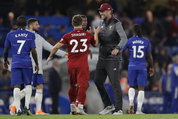 Liverpool&#039;s manager Juergen Klopp, second right, congratulates Liverpool&#039;s Xherdan Shaqiri after the English Premier League soccer match between Chelsea and Liverpool which ended in a 1-1 dr ...