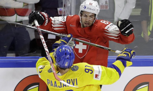 Switzerland&#039;s Simon Moser, above, challenges for the puck with Sweden&#039;s Magnus Paajarvi during the Ice Hockey World Championships final match between Sweden and Switzerland at the Royal aren ...