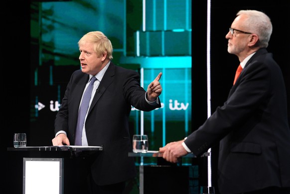 epa08009955 A handout photo made available by ITV shows British Prime Minister and Conservative Party leader Boris Johnson (L) and Labour Party leader Jeremy Corbyn (R) during live debate &#039;Johnso ...