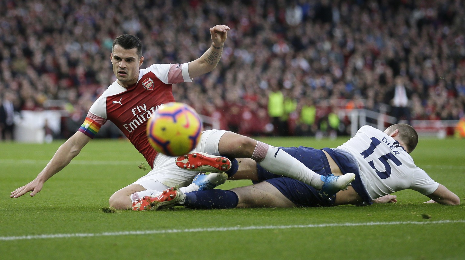 Arsenal&#039;s Granit Xhaka, left, fights for the ball with Tottenham&#039;s Eric Dier during the English Premier League soccer match between Arsenal and Tottenham Hotspur at the Emirates Stadium in L ...
